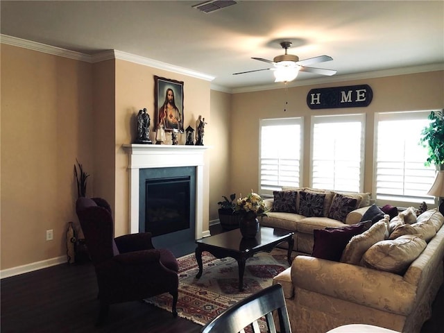 living area with ceiling fan, plenty of natural light, visible vents, and ornamental molding