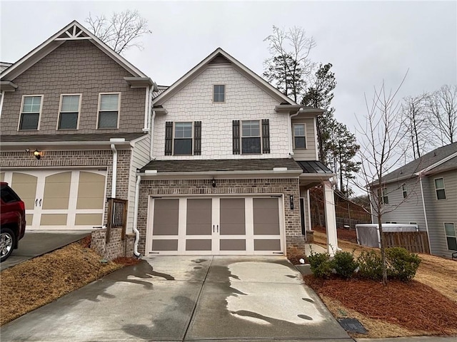 view of front of home featuring driveway, brick siding, an attached garage, and fence