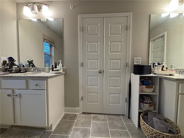 bathroom featuring vanity, tile patterned floors, and a closet