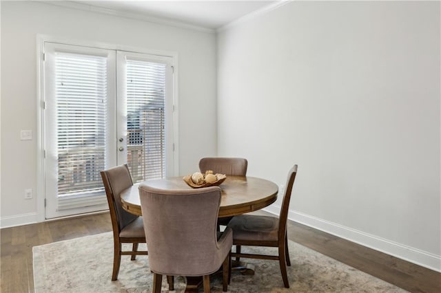 dining room featuring ornamental molding and hardwood / wood-style floors