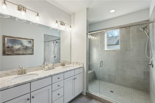 bathroom with tile patterned flooring, an enclosed shower, and vanity