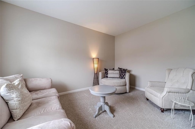 carpeted living room with baseboards