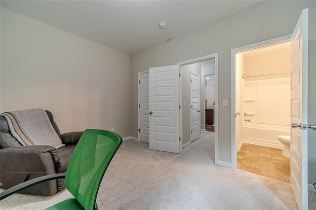 office with light carpet and baseboards