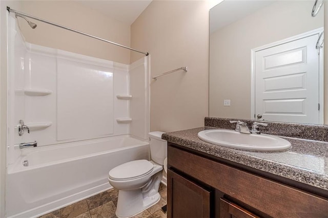bathroom featuring bathtub / shower combination, vanity, and stone finish floors
