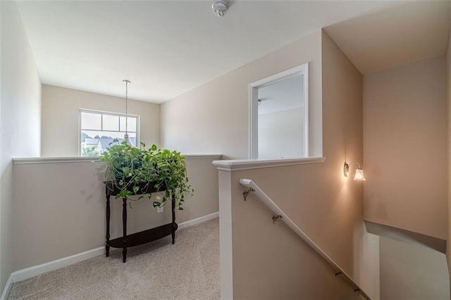 staircase featuring carpet flooring and baseboards