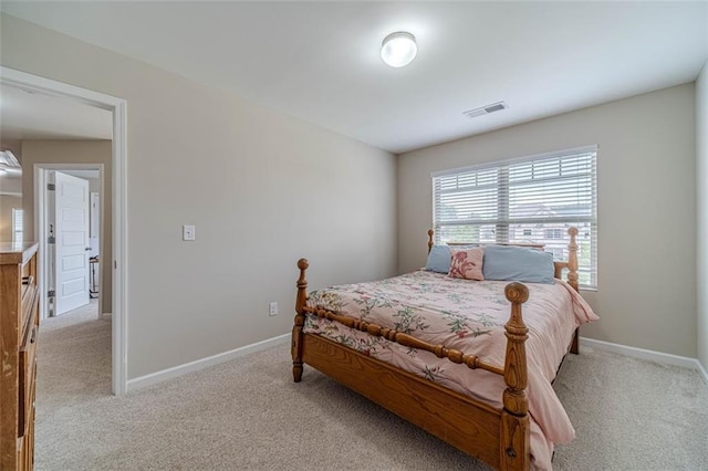 bedroom featuring light colored carpet