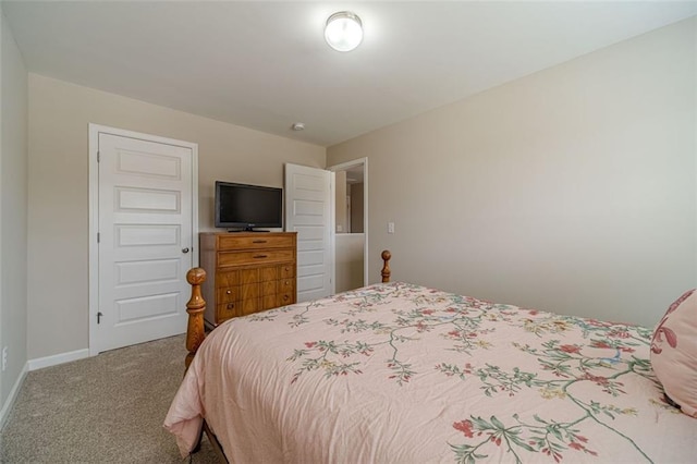 bedroom featuring carpet and baseboards