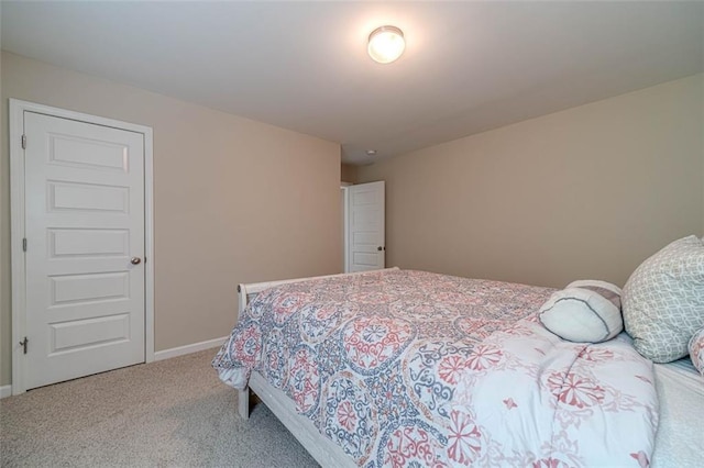 carpeted bedroom featuring baseboards