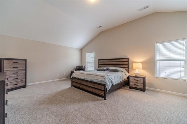 bedroom featuring vaulted ceiling and carpet floors