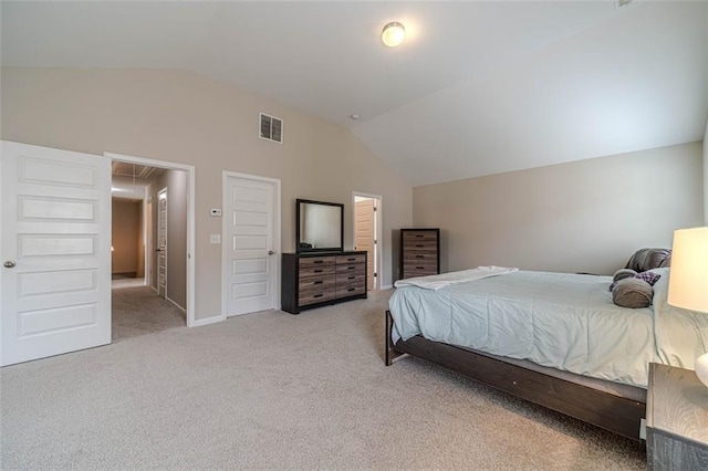 carpeted bedroom featuring vaulted ceiling and attic access