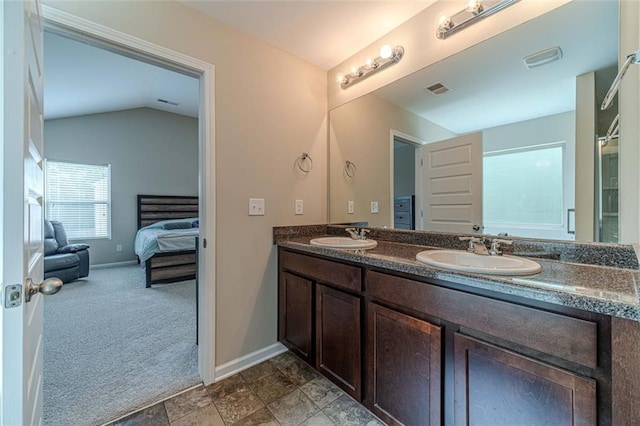 full bathroom featuring double vanity, ensuite bath, lofted ceiling, and a shower