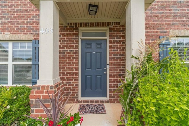 entrance to property with brick siding