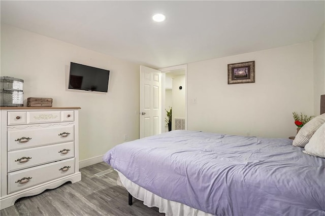 bedroom with hardwood / wood-style floors