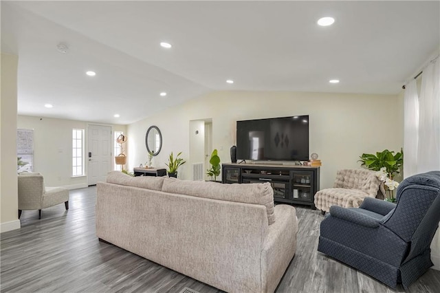 living room with hardwood / wood-style floors and lofted ceiling