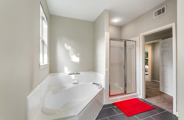 full bathroom featuring a stall shower, tile patterned flooring, visible vents, and a bath