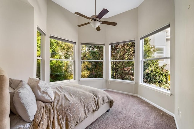 carpeted bedroom featuring ceiling fan and baseboards