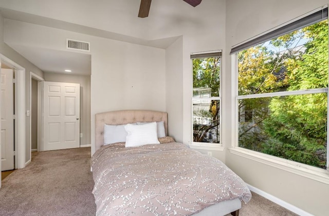 unfurnished bedroom with multiple windows, carpet, and visible vents