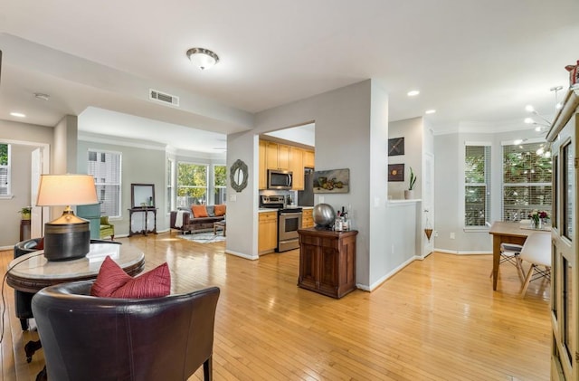 living area with recessed lighting, visible vents, an inviting chandelier, light wood-style floors, and baseboards