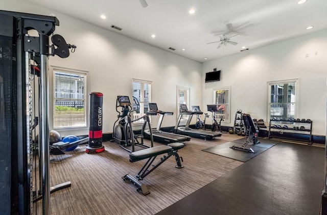 exercise room featuring ceiling fan, plenty of natural light, and visible vents