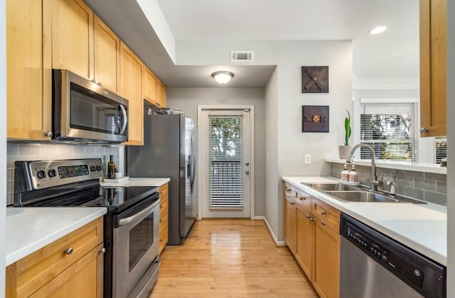 kitchen with a sink, visible vents, light countertops, appliances with stainless steel finishes, and plenty of natural light