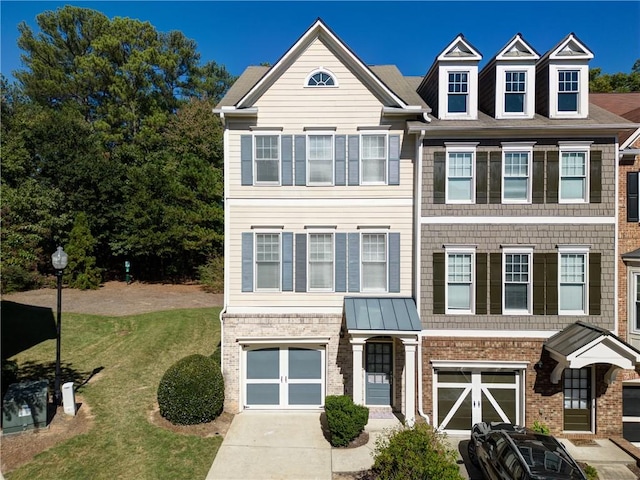 view of front of home with a garage and a front lawn