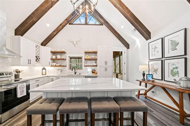 kitchen featuring a breakfast bar area, stainless steel electric stove, wall chimney range hood, open shelves, and a sink