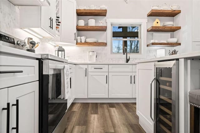 kitchen with beverage cooler, open shelves, tasteful backsplash, and under cabinet range hood