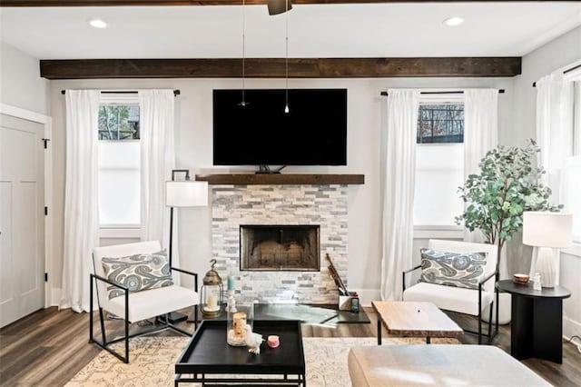 living area featuring recessed lighting, a fireplace, beamed ceiling, and wood finished floors