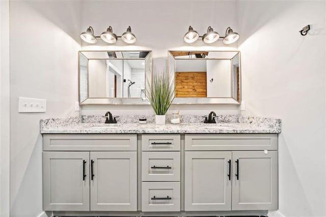 full bath featuring double vanity and a sink