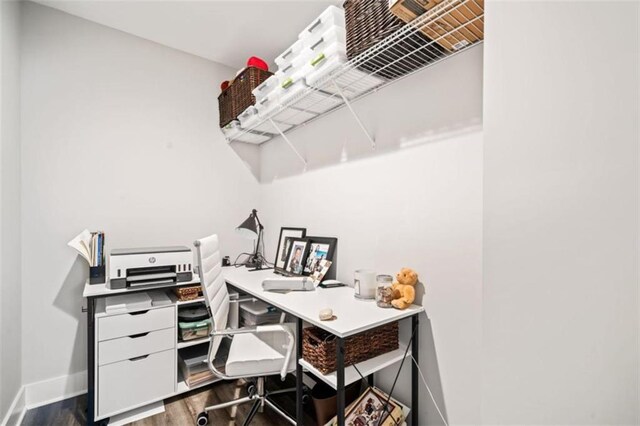 office area with dark wood-style floors and baseboards