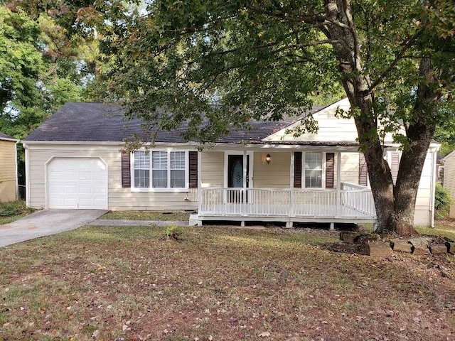 ranch-style home featuring driveway, a porch, a front lawn, and an attached garage