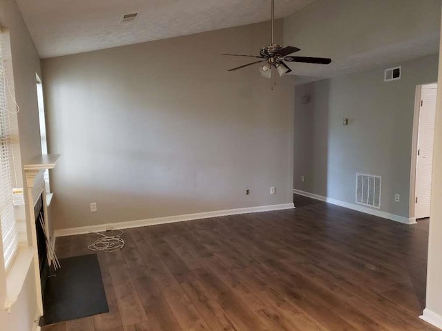 spare room featuring dark wood-style floors, baseboards, visible vents, and ceiling fan