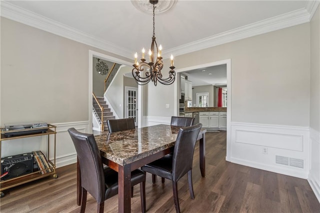310 Arbor Creek Trl, Roswell, GA 30076 - dining room featuring a chandelier, stairs, ornamental molding, dark wood-type flooring, and wainscoting