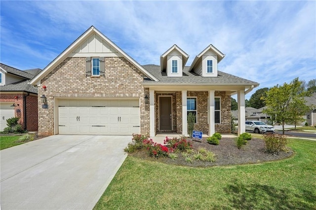 view of front of house featuring a garage, a front lawn, and covered porch