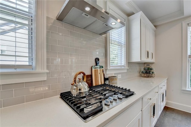 8305 Beryl Overlook, Gainesville, GA 30506 - kitchen with ventilation hood, stainless steel gas cooktop, white cabinets, plenty of natural light, and crown molding
