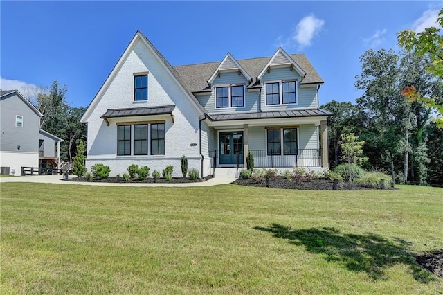 8305 Beryl Overlook, Gainesville, GA 30506 - view of front of home featuring a standing seam roof, covered porch, a front lawn, and metal roof