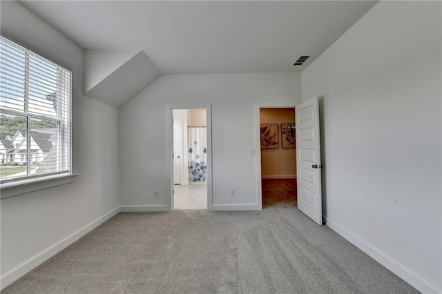 8305 Beryl Overlook, Gainesville, GA 30506 - unfurnished bedroom featuring a spacious closet, multiple windows, carpet floors, baseboards, and lofted ceiling