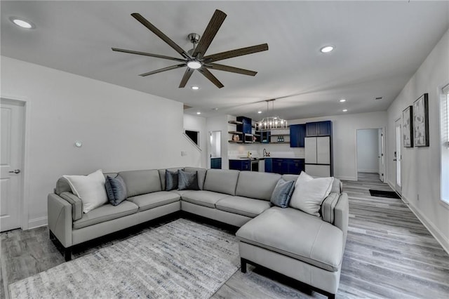 8305 Beryl Overlook, Gainesville, GA 30506 - living room with light wood-style floors, a ceiling fan, recessed lighting, a chandelier, and baseboards