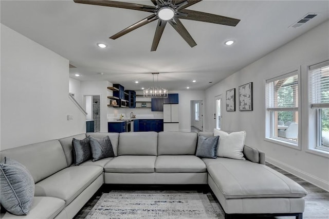 8305 Beryl Overlook, Gainesville, GA 30506 - living room with recessed lighting, a chandelier, ceiling fan, light wood-style floors, and baseboards