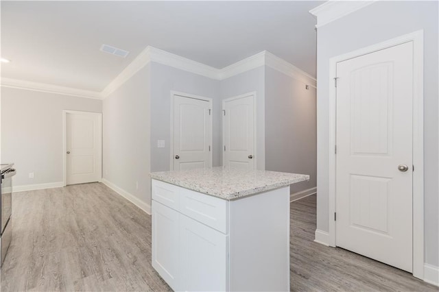 kitchen featuring light wood-style floors, baseboards, ornamental molding, and white cabinets