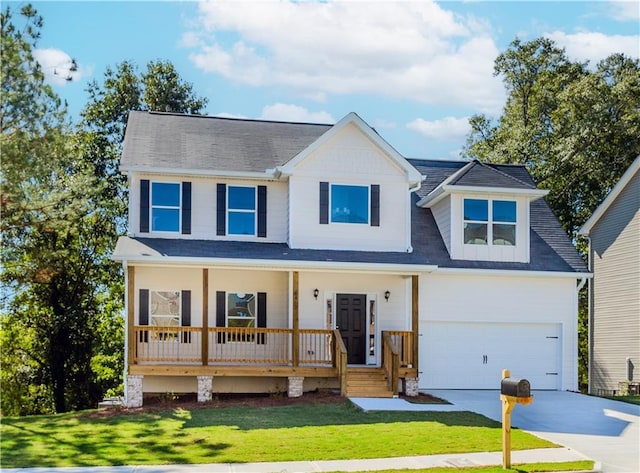 view of front of property with a garage, concrete driveway, a porch, and a front yard