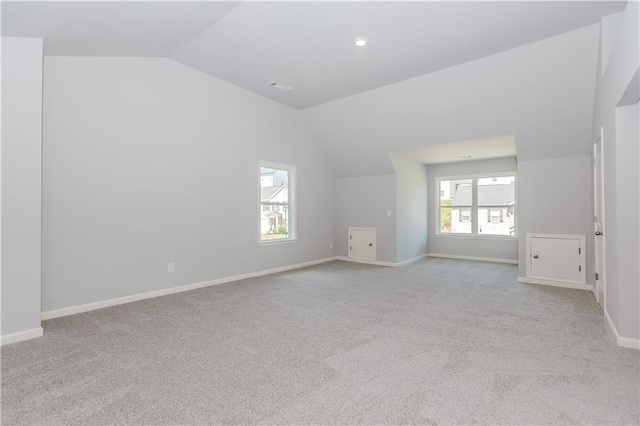 unfurnished room featuring baseboards, vaulted ceiling, and carpet flooring