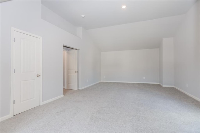 interior space with recessed lighting, vaulted ceiling, and baseboards