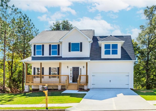 view of front of house featuring driveway, a garage, a porch, and a front yard