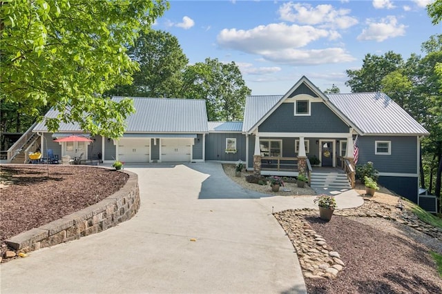 1832 Monument Rd, Jasper, GA 30143 - view of front facade with a porch, driveway, an attached garage, and a metal roof