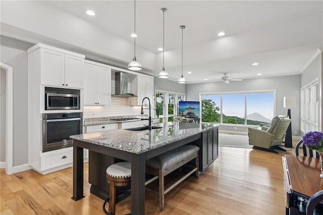 1832 Monument Rd, Jasper, GA 30143 - kitchen with stainless steel appliances, wall chimney exhaust hood, a kitchen breakfast bar, white cabinets, and recessed lighting