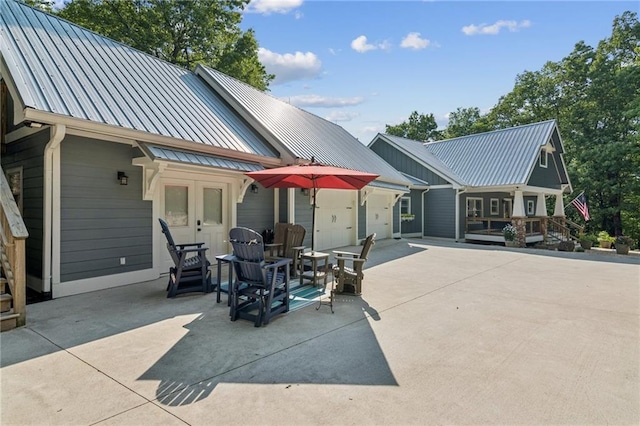 1832 Monument Rd, Jasper, GA 30143 - back of house with a metal roof, driveway, and an attached garage