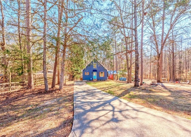 view of front of home featuring concrete driveway and a front lawn