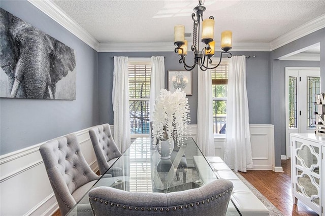 10 Callaway Ct, Hiram, GA 30141 - dining space with a textured ceiling, a chandelier, ornamental molding, and wood finished floors