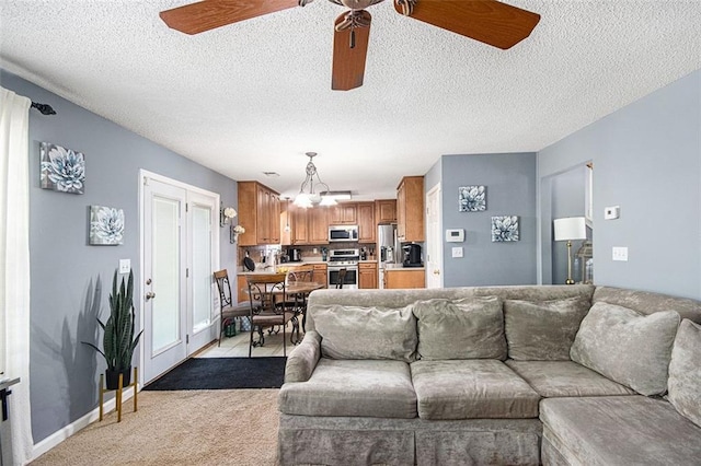 10 Callaway Ct, Hiram, GA 30141 - living area featuring a textured ceiling, light carpet, and ceiling fan with notable chandelier
